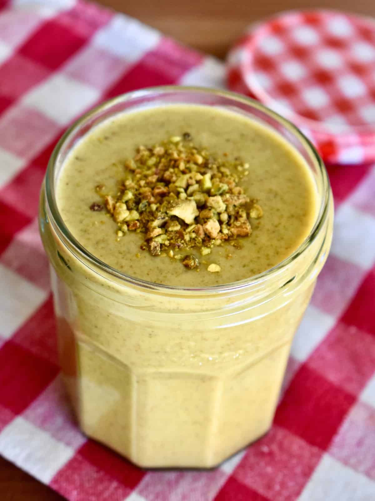 Italian pistachio cream in a glass jar.