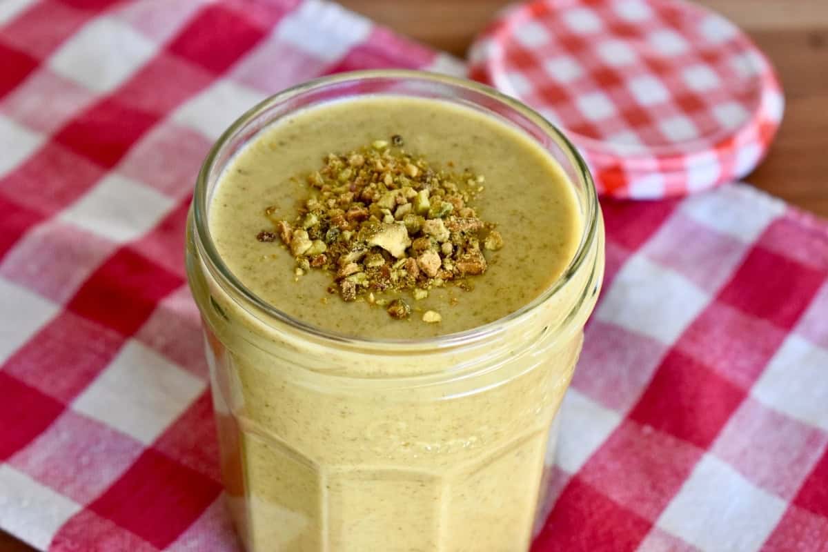 Pistachio cream in small glass jar. 
