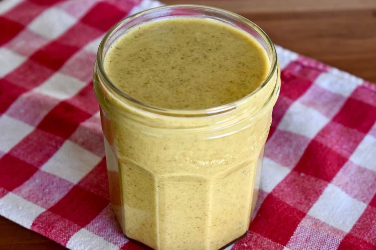 Italian Pistachio cream in a glass jar on a checkered napkin. 