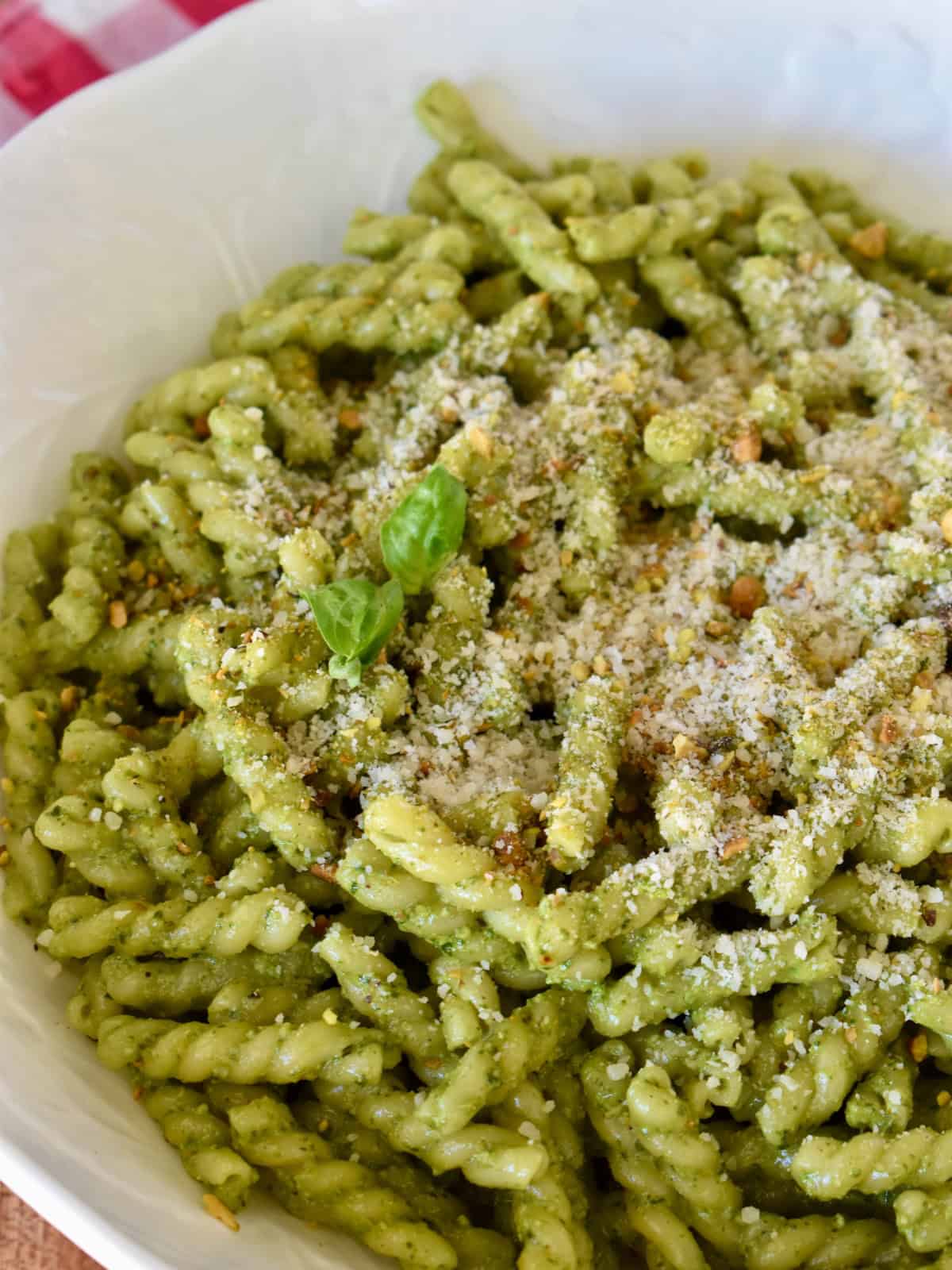 Pistachio pesto pasta in a large white bowl. 