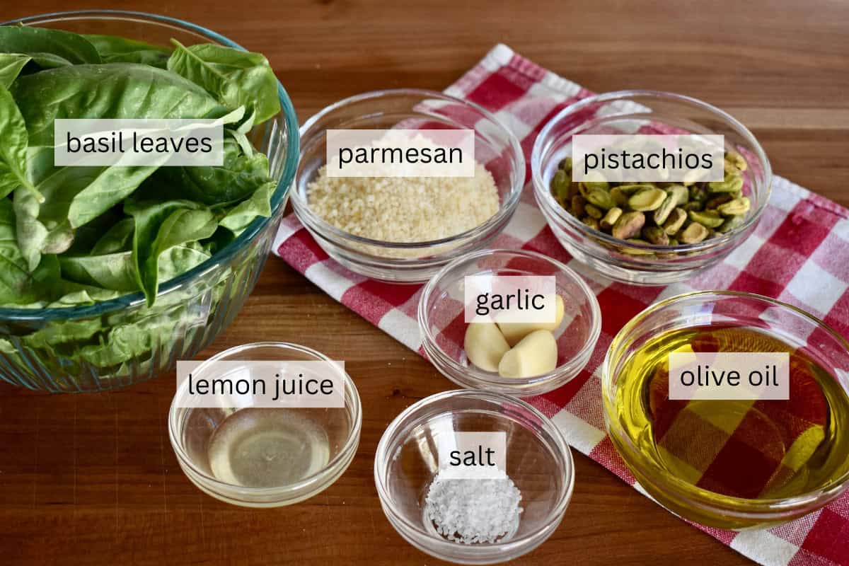Ingredients include basil, nuts, salt, olive oil, lemon juice, garlic, and cheese. 