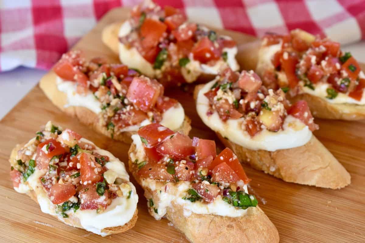 Ricotta Bruschetta on a wood cutting board. 