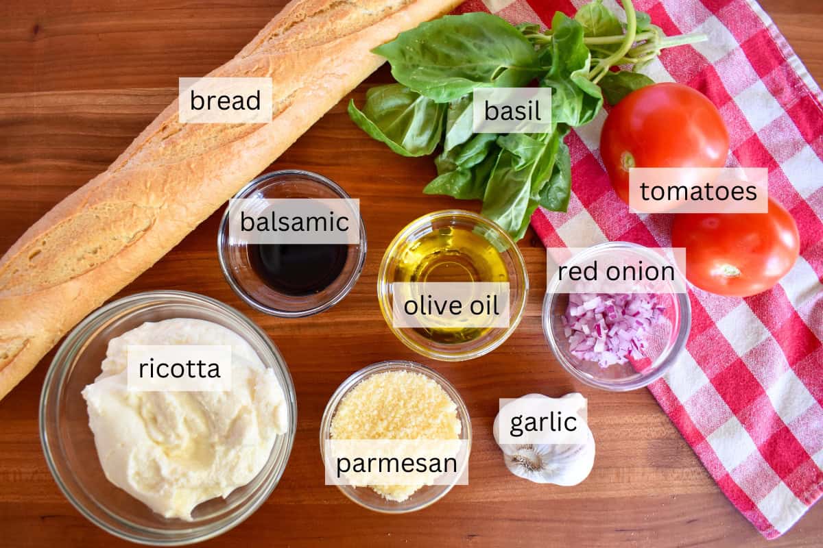 Ingredients for recipe including tomatoes, basil, cheese, and garlic. 
