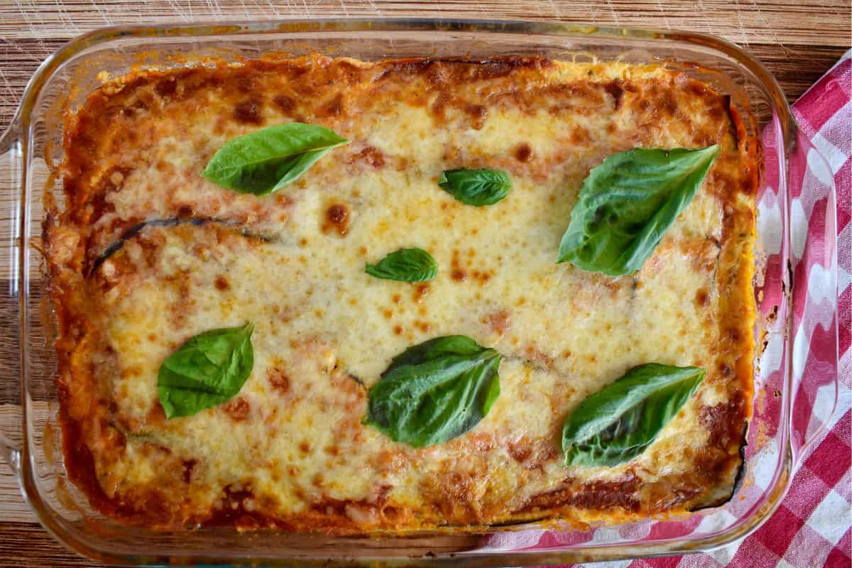 Eggplant Lasagna with basil on top in a glass baking pan. 