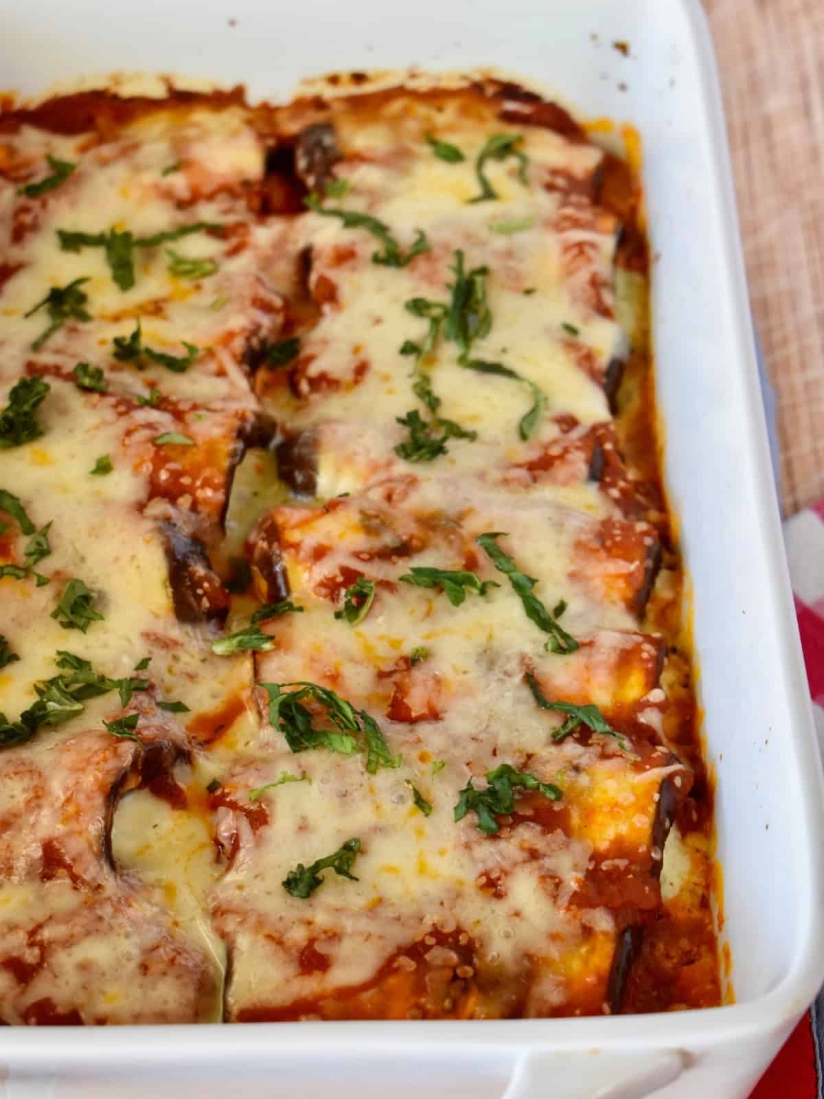 Eggplant rollatini in a white baking dish.