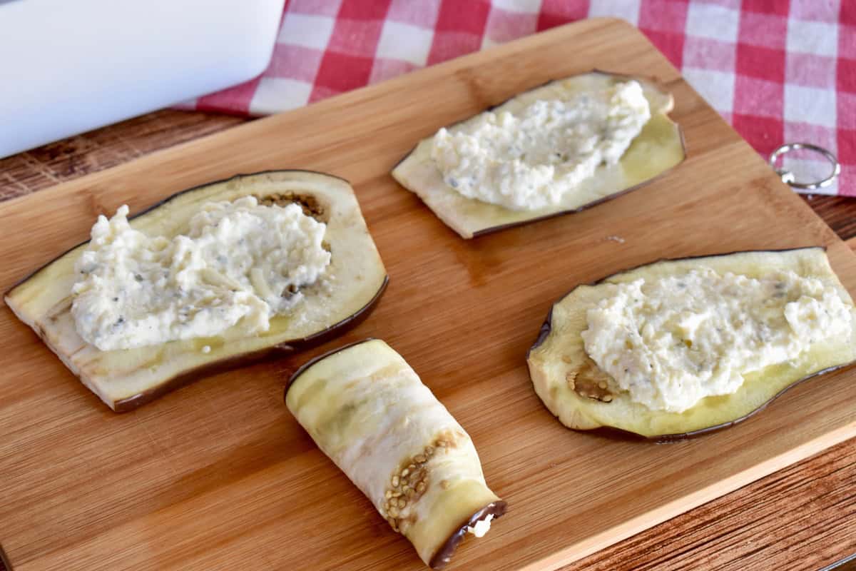 Slices of eggplant with ricotta filling rolled in them. 