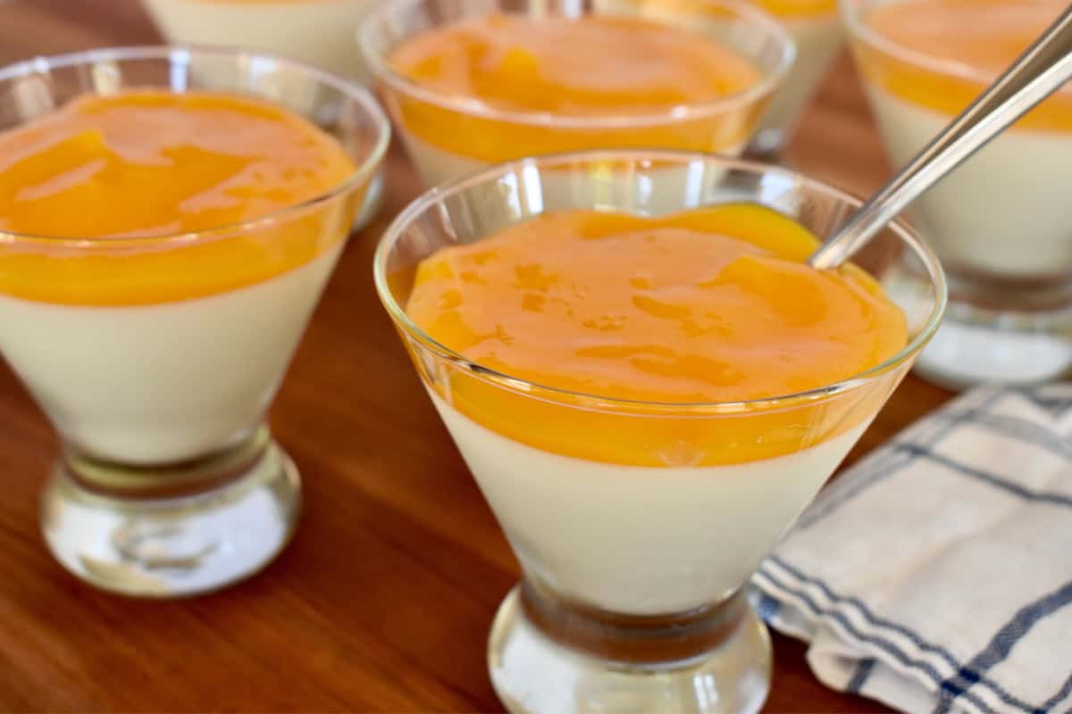 Mango Panna Cotta with a spoon in it. 