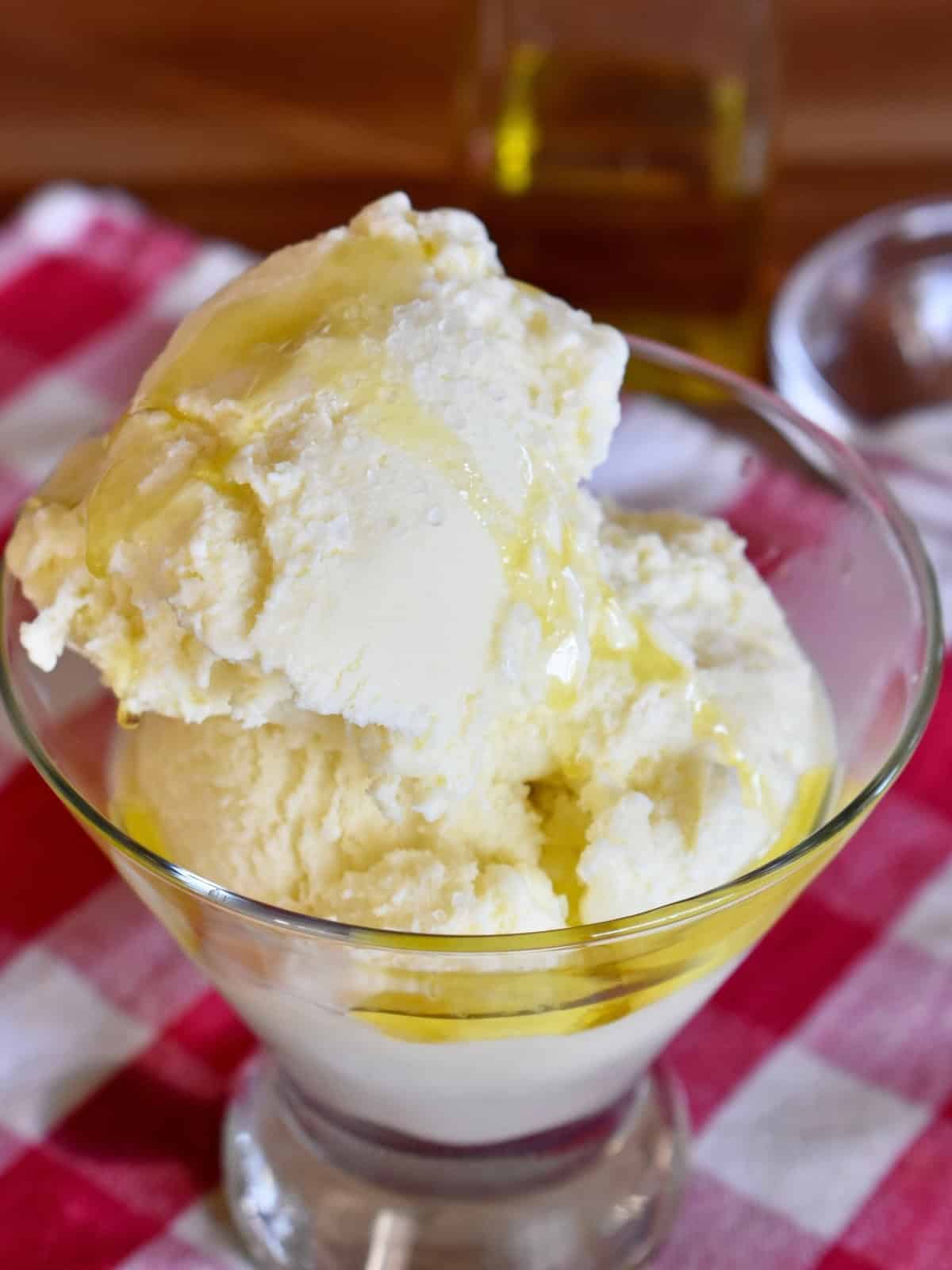 Olive oil gelato in a glass with olive oil and sea salt sprinkled on top.