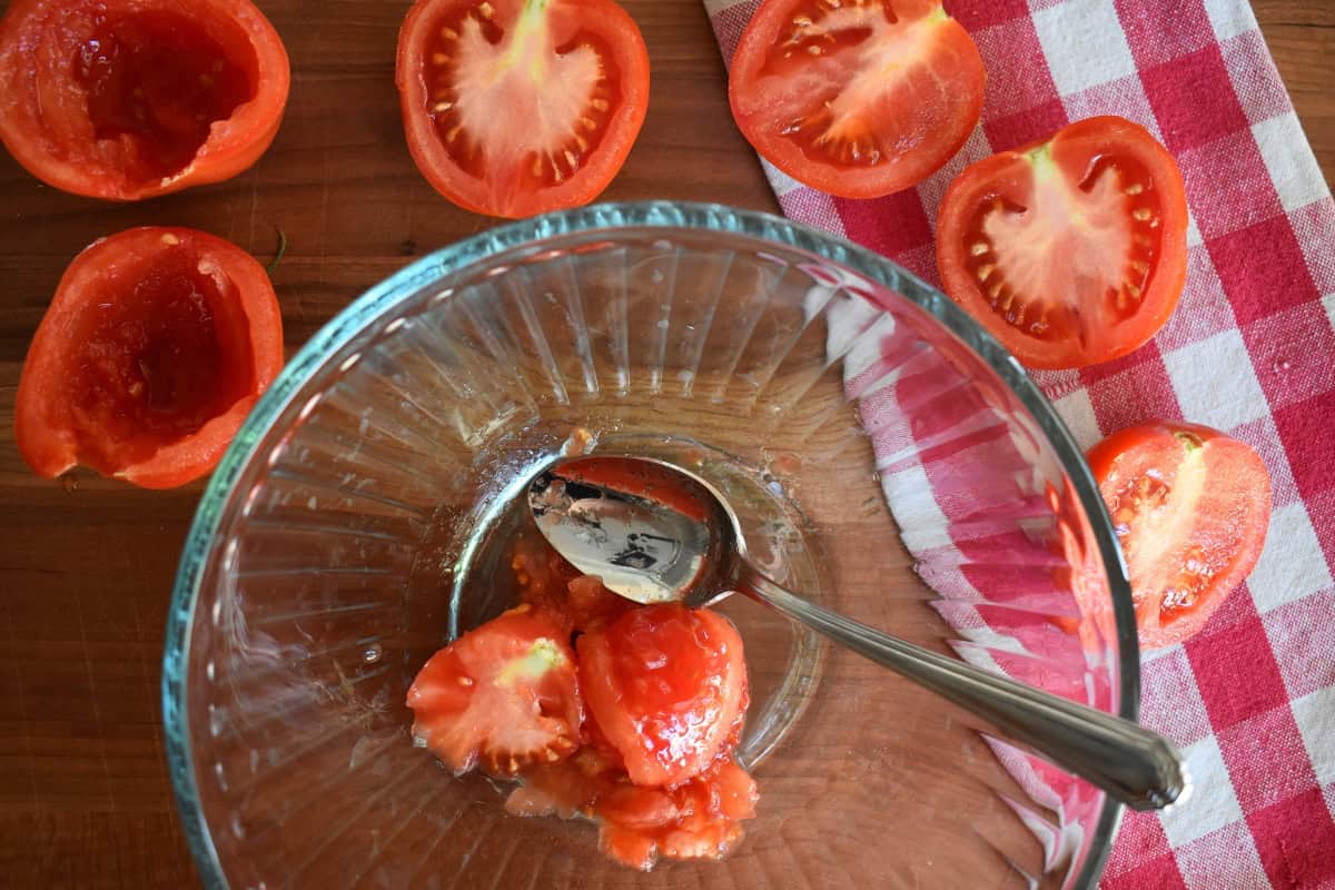 Tomatoes cut in half with their seeds and core removed. 