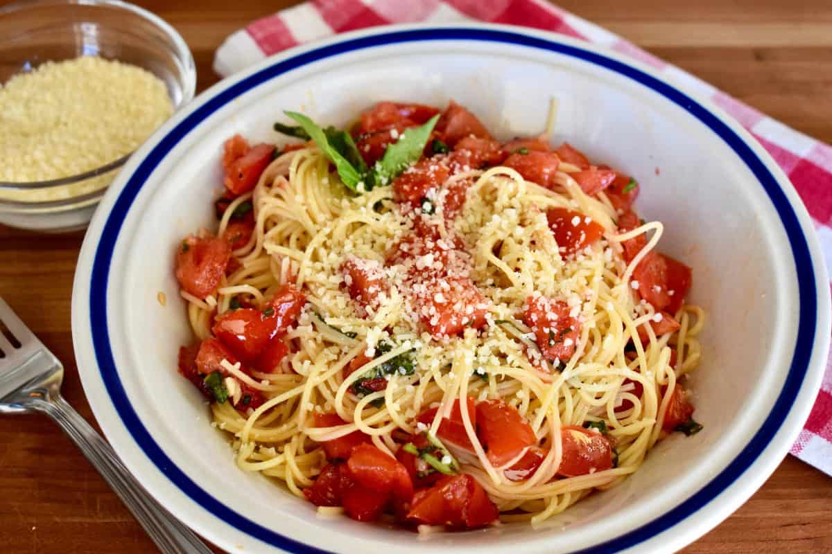 Spaghetti al Pomodoro Crudo in a white bowl. 