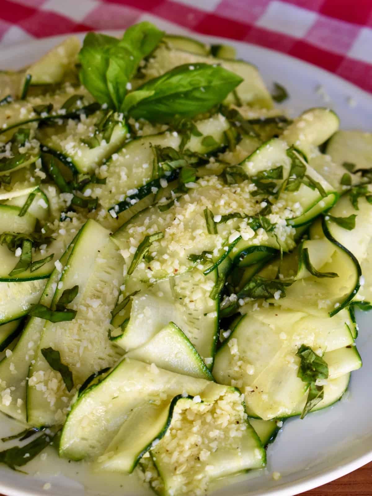Zucchini Carpaccio on a white plate.