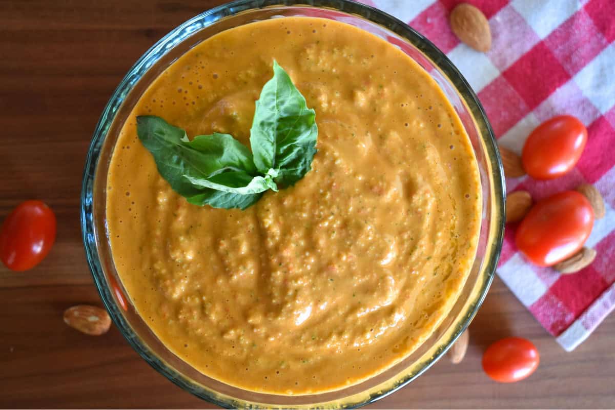 Sicilian pesto in a glass bowl with basil on top. 