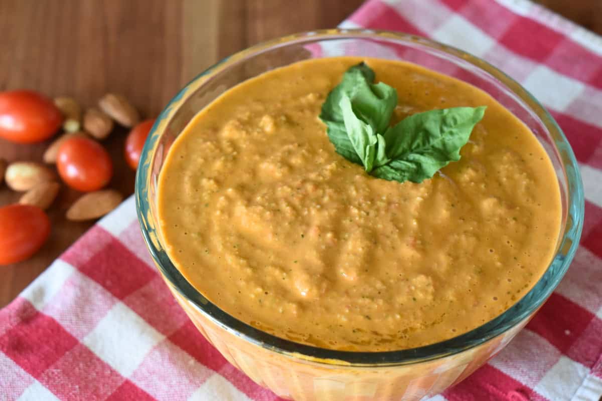 Bowl of Sicilian pesto with a basil leaf on top. 
