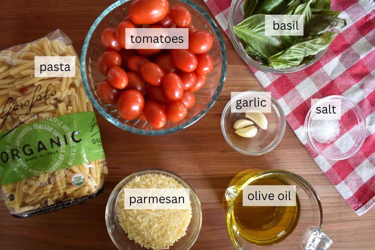 Ingredients include cherry tomatoes, olive oil, almonds, basil, and parmesan. 