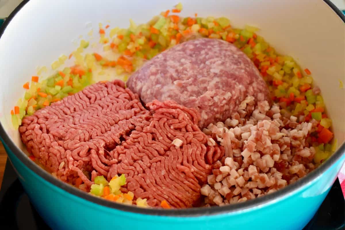 Ground pork, beef, and pancetta added to the dutch oven. 