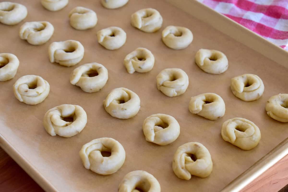 Taralli Pugliese on a lined baking sheet. 