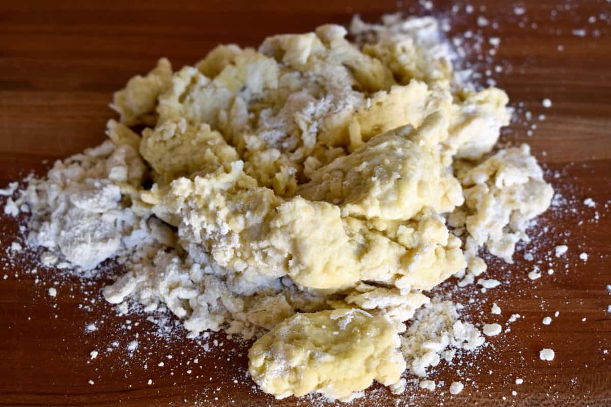 Dough for recipe on wood countertop. 